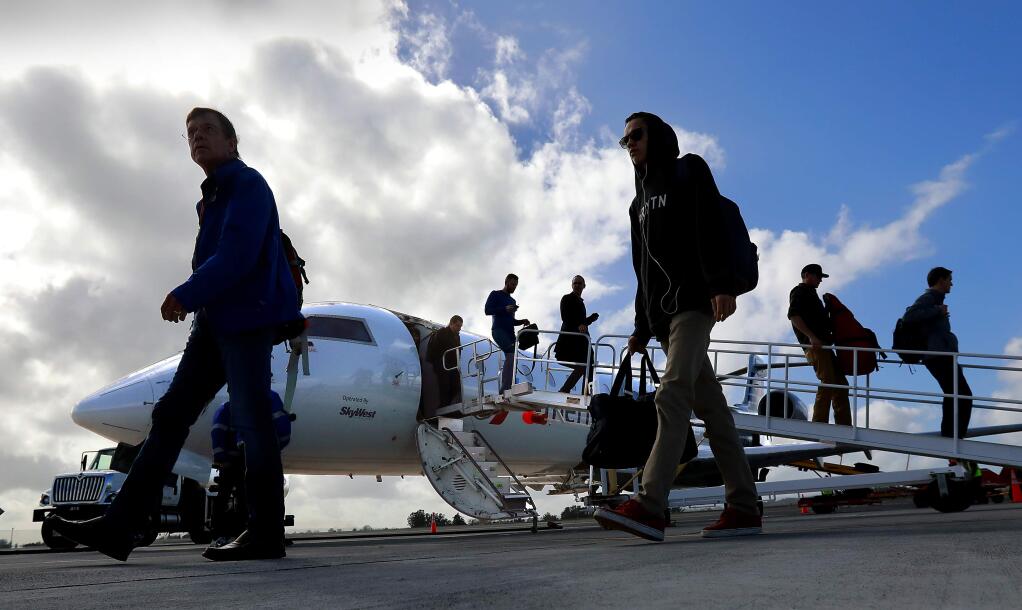 Passengers arrive on the first American Airlines flight from Phoenix at the Charles M. Schulz-Sonoma County Airport on Thursday afternoon, February 16, 2017. The airline is adding a second daily flight to Phoenix from Sonoma County in July to meet passenger demand for the service. (John Burgess/The Press Democrat)