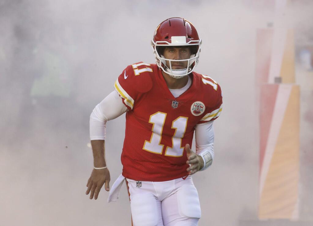 In this Oct. 15, 2017, file photo, Kansas City Chiefs quarterback Alex Smith runs onto the field against the Pittsburgh Steelers in Kansas City, Mo. The Oakland Raiders came into the season trying to chase the Kansas City Chiefs for AFC West dominance. The Raiders head into the first meeting between the rivals this season on a four-game losing streak and desperate for any kind of win. (AP Photo/Charlie Riedel, File)
