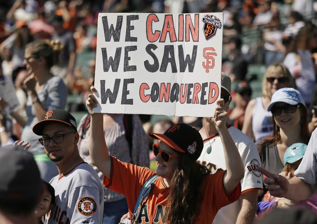 Jessaline Tuason holds up a sign for San Francisco Giants starting pitcher Matt Cain before the start of a baseball game between the Giants and the San Diego Padres Saturday, Sept. 30, 2017, in San Francisco. Cain plans to retire at the end of the season and is making his last start. (AP Photo/Eric Risberg)