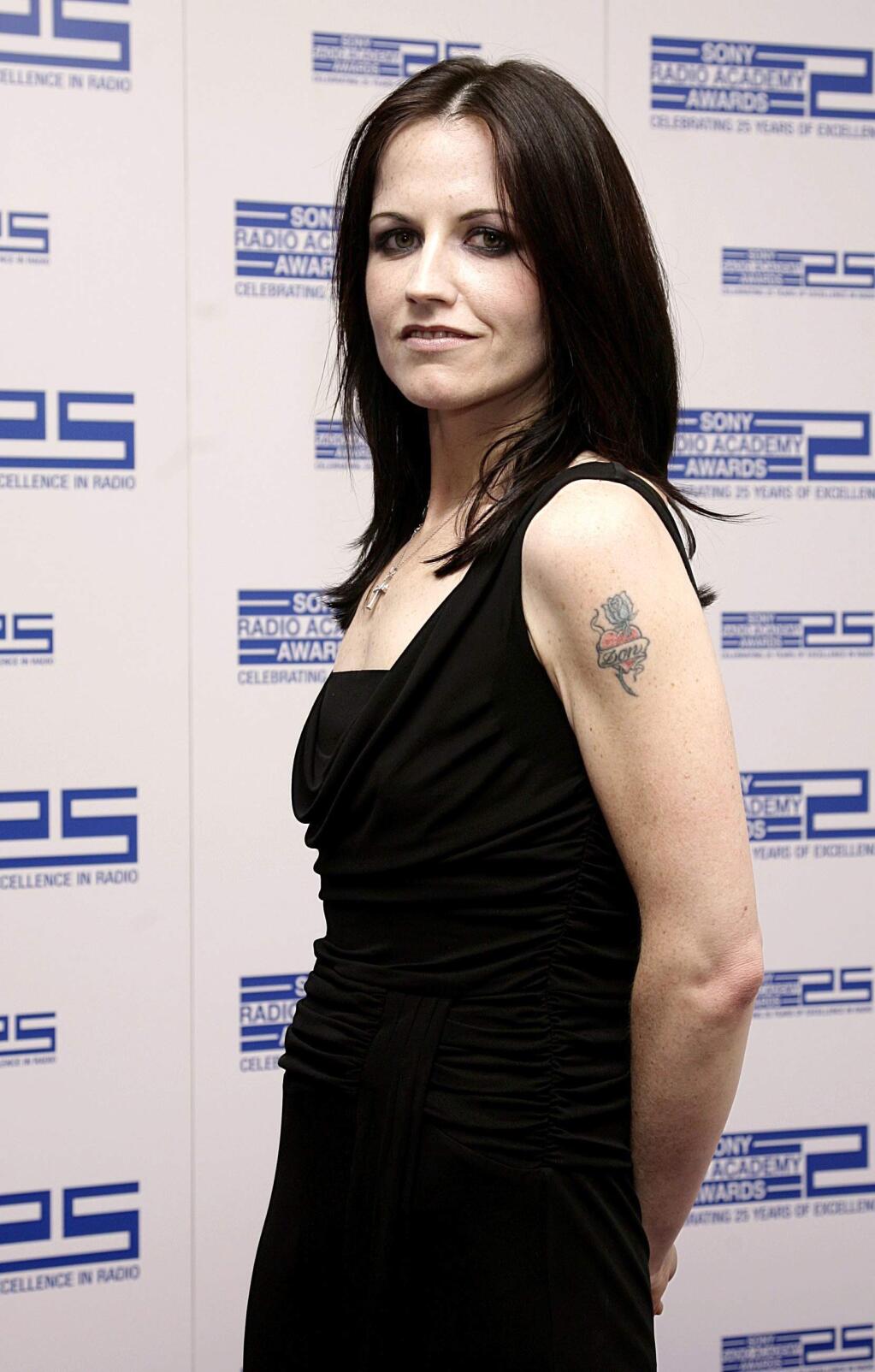 FILE - In this April 30, 2004 file photo, singer Dolores O'Riordan poses for photographers at the Sony Radio Academy Awards 2007, in London. Dolores O'Riordan, lead singer of Irish band The Cranberries, has died. She was 46, it was reported Monday, Jan. 15, 2018. (Yui Mok/PA via AP, File)