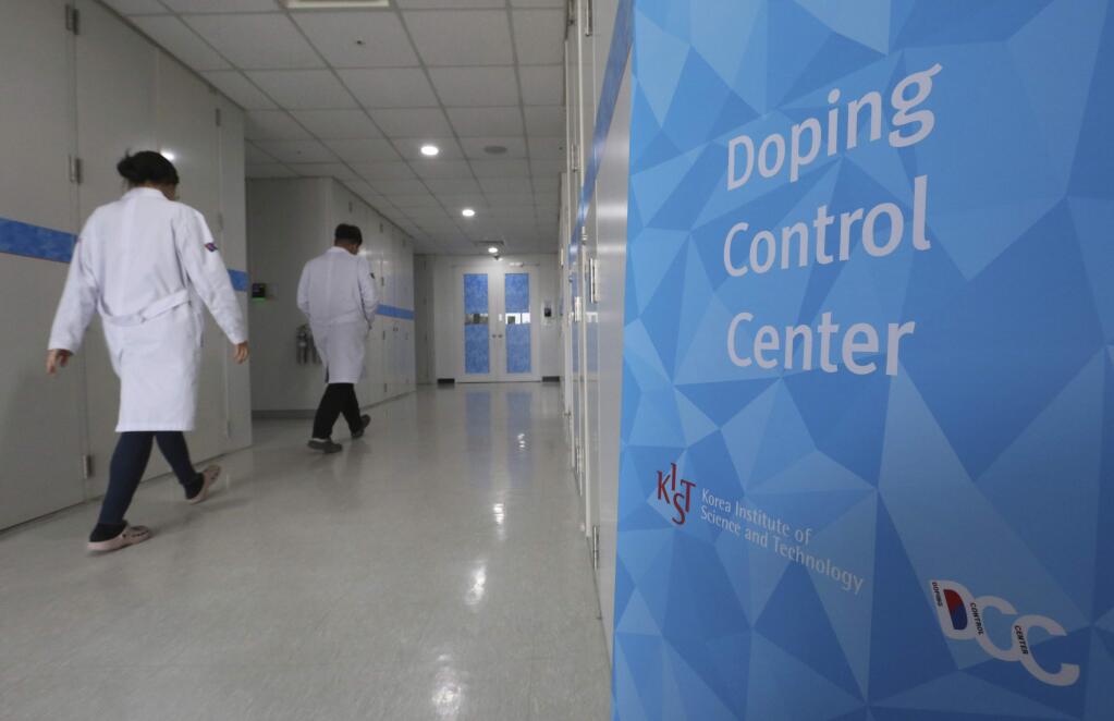 Researches enter into the Doping Control Center at the Korea Institute of Science and Technology in Seoul, South Korea, Monday, Feb. 19, 2018. Russia could lose its chance to be reinstated before the end of the Winter Olympics because of a doping charge against curling bronze medalist Alexander Krushelnitsky. (AP Photo/Ahn Young-joon)