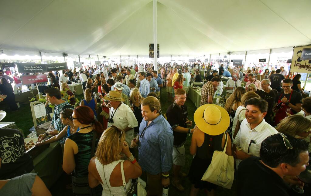 A large crowd tries the various wines and food at Saturday's Taste of Sonoma event in Healdsburg, Aug. 30, 2014. (Conner Jay/Press Democrat)