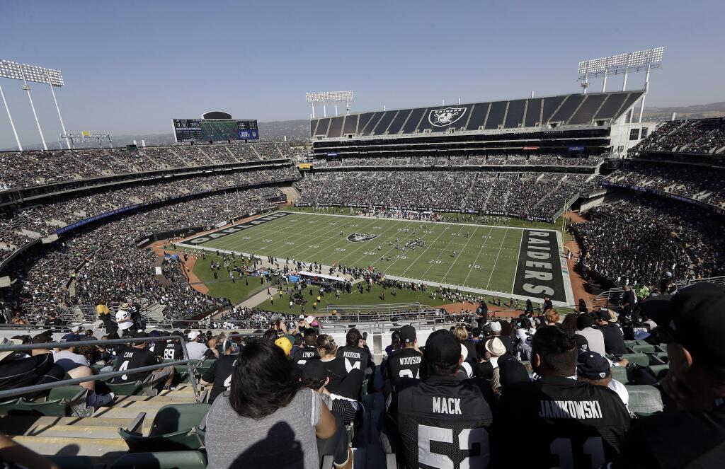 Fans watch at Oakland Alameda-County Coliseum during the first half between the Oakland Raiders and the Baltimore Ravens Sunday, Oct. 8, 2017. (AP Photo/Marcio Jose Sanchez)