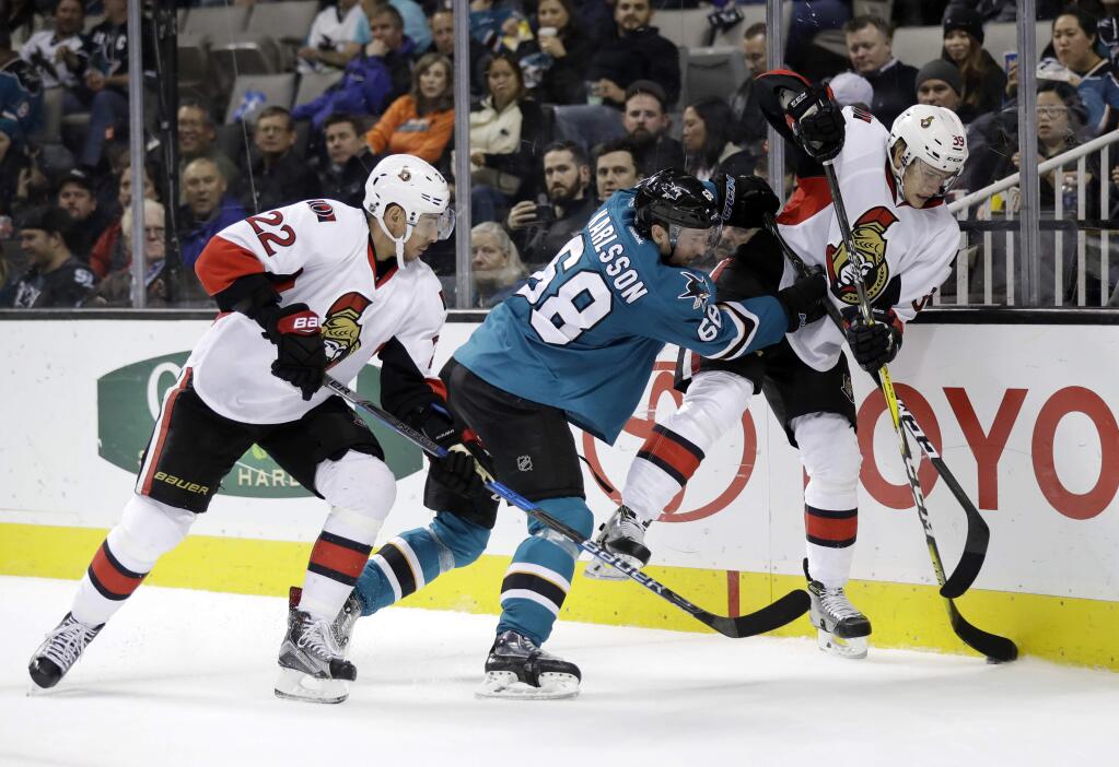Ottawa Senators' Andreas Englund, right, is checked against the boards by San Jose Sharks' Melker Karlsson (68) during the first period Wednesday, Dec. 7, 2016, in San Jose. (AP Photo/Marcio Jose Sanchez)