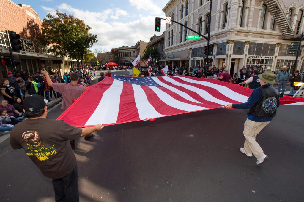 'Natives Sons of the Golden West' cary a large flag at the 2017 annual Veteran's Day Parade in Petaluma, on Saturday, November 11, 2017. The parade is back in Petaluma again this year. \ (Photo by Darryl Bush / For The Press Democrat)