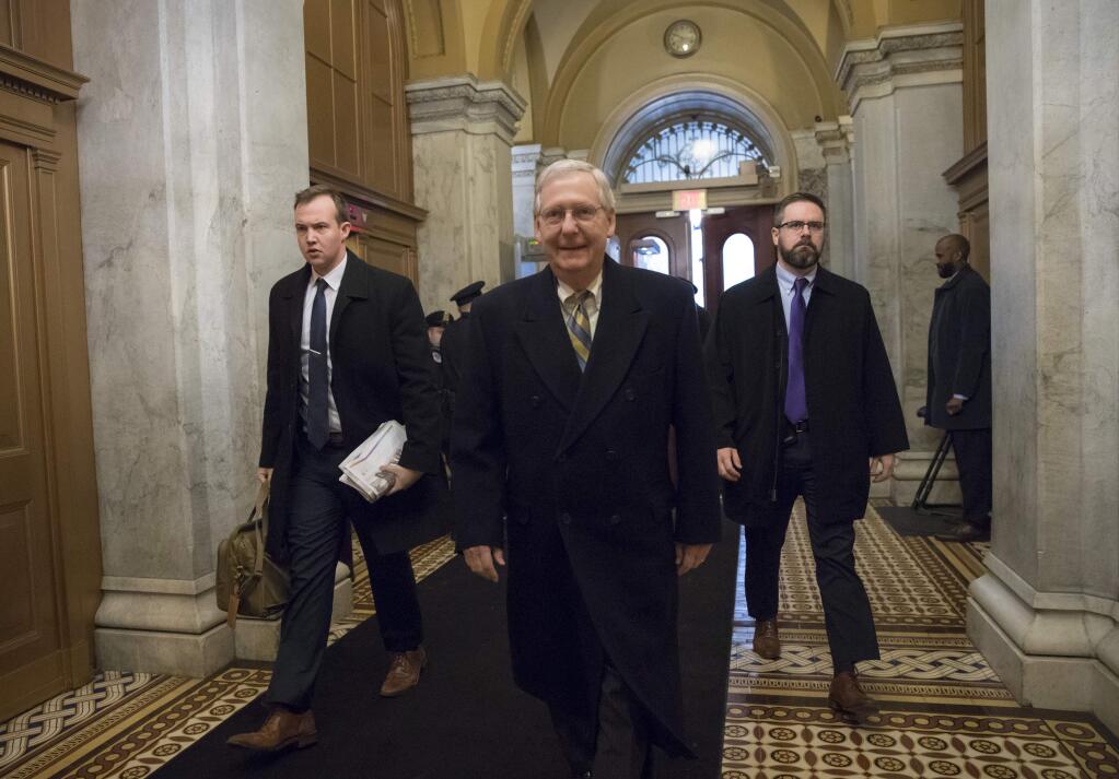 Senate Majority Leader Mitch McConnell, R-Ky., arrives at the Capitol in Washington, Friday, Jan. 19, 2018, as a bitterly-divided Congress hurtles toward a government shutdown this weekend in a partisan stare-down over demands by Democrats for a solution on politically fraught legislation to protect about 700,000 younger immigrants from being deported. (AP Photo/J. Scott Applewhite)