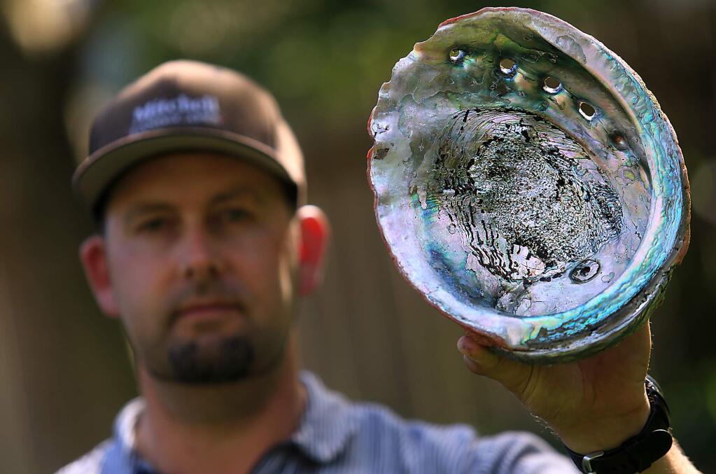 Abalone Diver Owen Mitchell of Cotati displays an abalone from a past expedition to the Sonoma Coast, Friday March 31, 2017. (Kent Porter / The Press Democrat) 2017