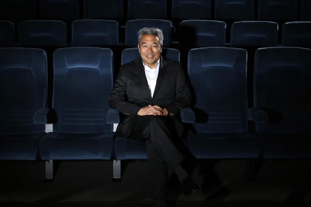 FILE - In this Feb. 6, 2013, file photo, Kevin Tsujihara, poses for photos in a screening room at the Warner Bros. Studios in Burbank, Calif. WarnerMedia is investigating claims that Warner Bros. chairman and CEO Tsujihara promised acting roles in exchange for sex as detailed in The Hollywood Reporter, Wednesday, March 6, 2019. (AP Photo/Jae C. Hong, File)