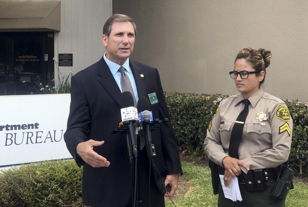 Los Angeles County sheriff's Lt. John Corina, left, speaks next to Deputy Joana Warren outside of the sheriff's homicide bureau office in Monterey Park, Calif., Thursday, April 19, 2018. Los Angeles County sheriff's investigators say a 16-year-old was arrested on suspicion of murder after his teenage friend was found stabbed to death. (AP Photo/Mike Balsamo)