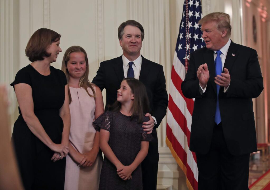 President Donald Trump talks with Judge Brett Kavanaugh his Supreme Court nominee, and his family in the East Room of the White House, Monday, July 9, 2018, in Washington. (AP Photo/Alex Brandon)