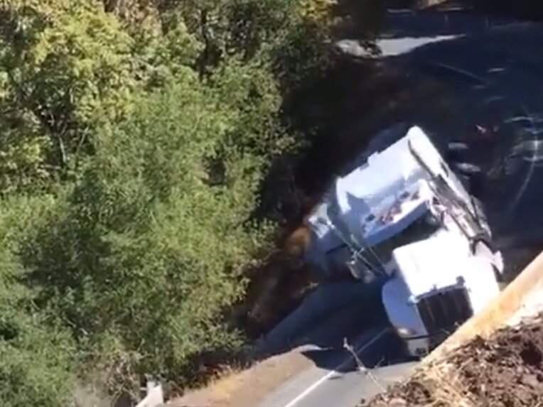 A screenshot from video showing a truck that crashed down an embankment on State Route 175 in Mendocino County on Thursday, Oct. 11, 2018. (COURTESY OF CALTRANS)