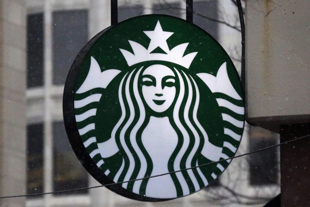 FILE - This March 14, 2017, file photo show the Starbucks logo on a shop in downtown Pittsburgh. Starbucks is announcing a new policy that allows anyone to sit in its cafes or use its restrooms, even if they don't buy anything. Company executives have said its previous policies were loose and ambiguous, leaving decisions on whether people could sit in its stores or use the restroom up to store managers. Starbucks said Saturday, May 19, 2018 it has told workers to consider anyone who walks into its stores a customer, 'regardless of whether they make a purchase.' (AP Photo/Gene J. Puskar, File)