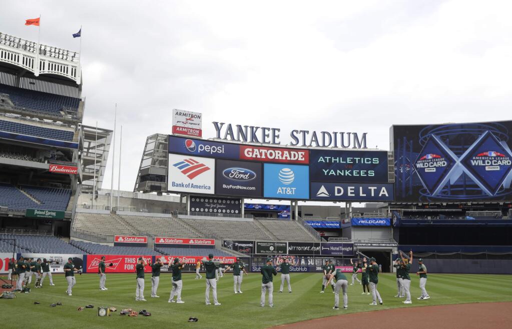 The Oakland Athletics warm up during a baseball team workout in New York, Tuesday, Oct. 2, 2018. The Athletics play the New York Yankees in an American League wildcard game on Wednesday. (AP Photo/Frank Franklin II)