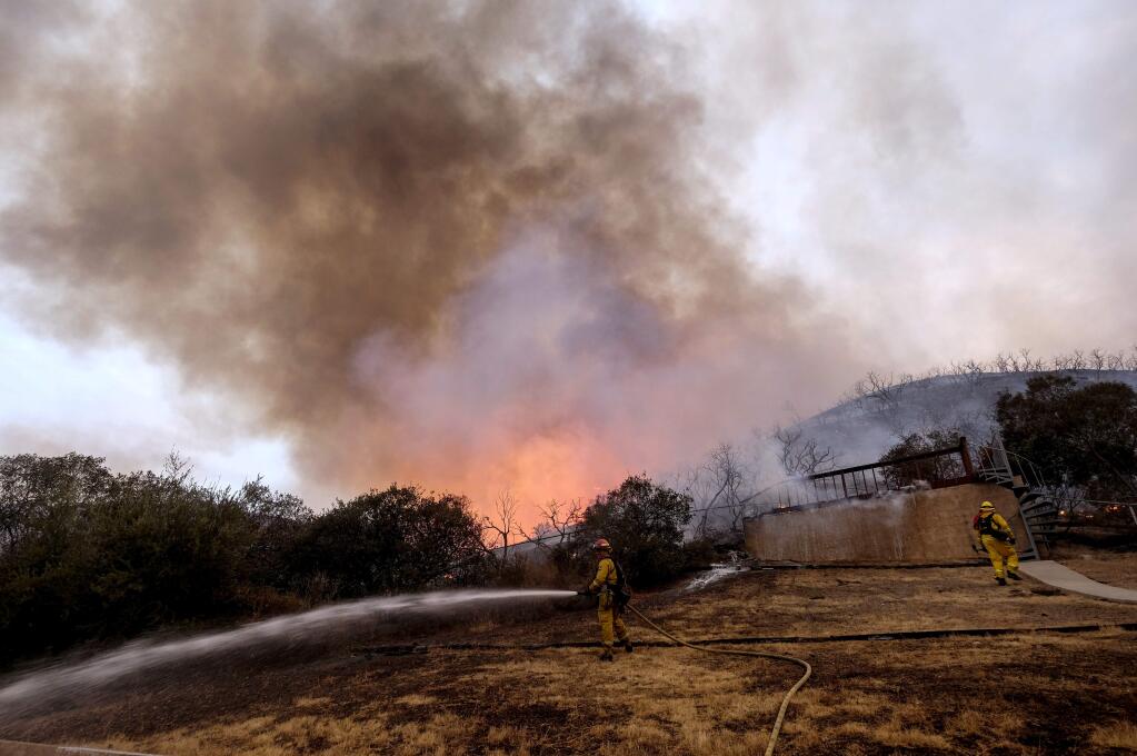 Firefighters battle the Holy Fire burning in the Cleveland National Forest in Lake Elsinore, Calif., Thursday, Aug. 9, 2018. (AP Photo/Ringo H.W. Chiu)