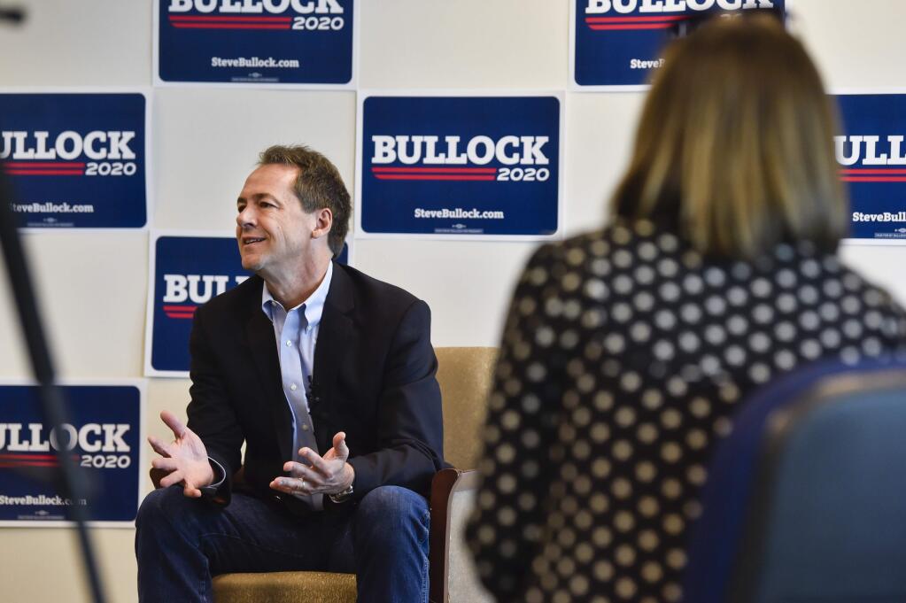 Gov. Steve Bullock, Democratic presidential candidate, holds a roundtable discussion with members of the local media Tuesday, May 14, 2019 at his campaign headquarters in Helena, Mont. (Thom Bridge/Independent Record via AP)