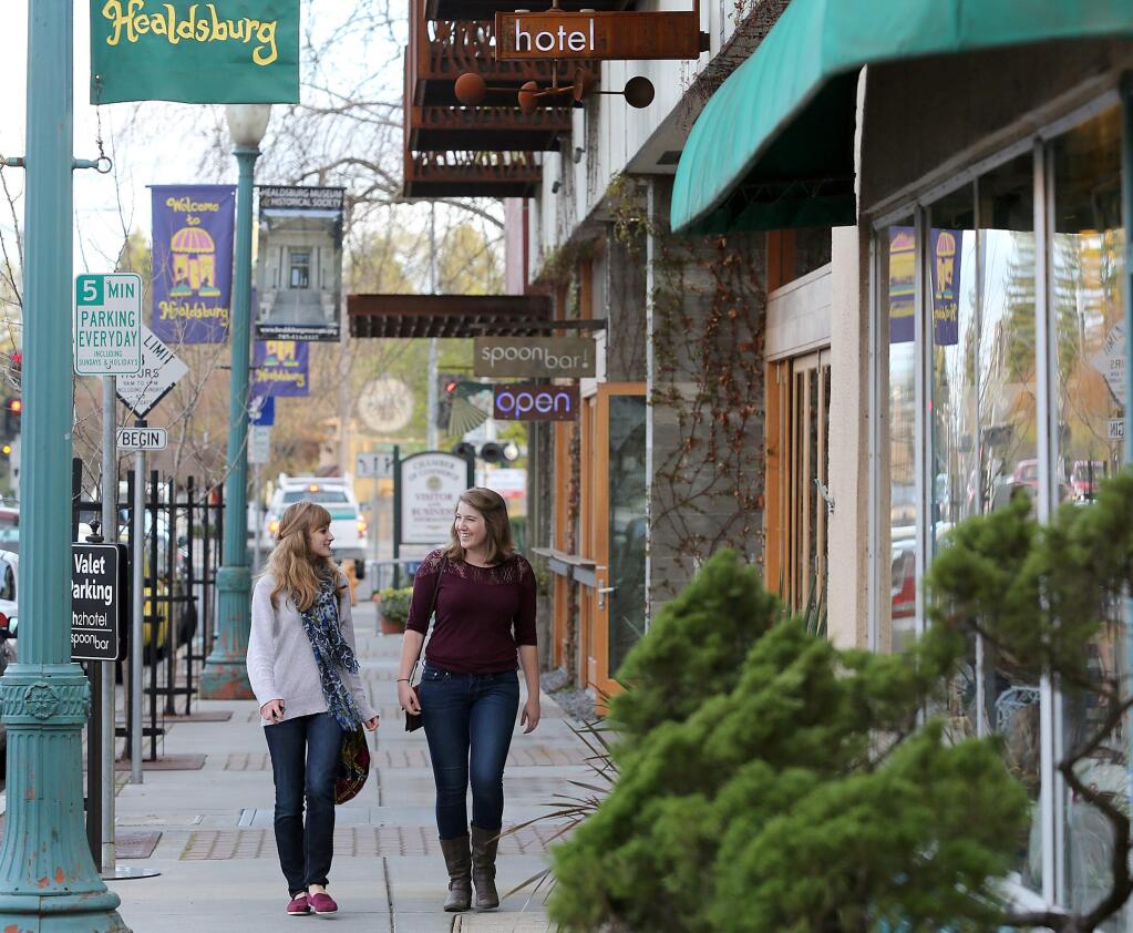 Cheyenne Henley, left, and Samantha Nickel, right, both of Santa Rosa, walk by Spoonbar and the H2Hotel in downtown Healdsburg in 2013. (The Press Democrat file)