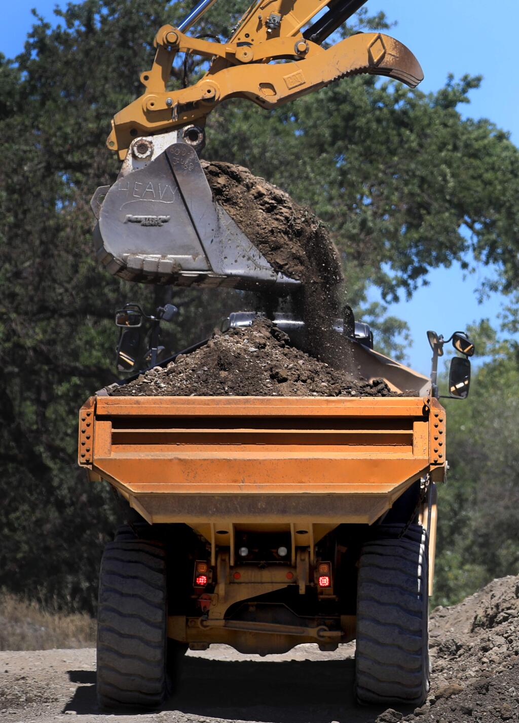 Fill dirt is loaded to be used for the road bed on the Asti summer crossing over the Russian River, Thursday, May 28, 2020 south of Cloverdale, The county is couldn't install a bridge this year, because the river changed course. Officials are looking for a permanent fix. (Kent Porter / The Press Democrat) 2020