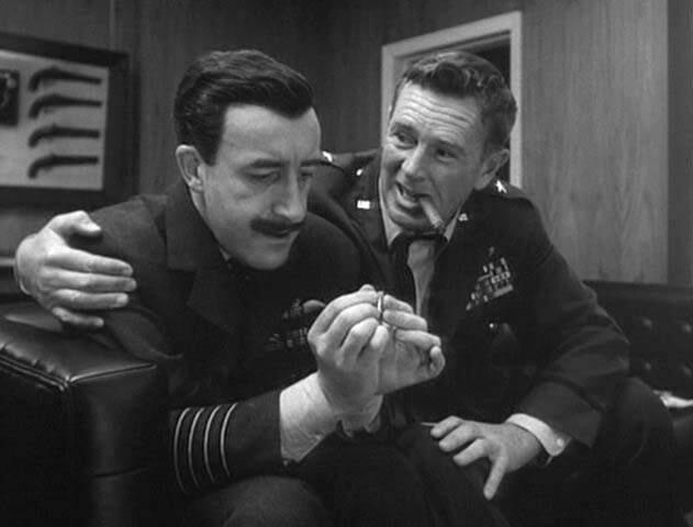 Ripper (Sterling Hayden, right) lobbies Mandrake (Peter Sellers) as to the drawbacks of fluoridation.