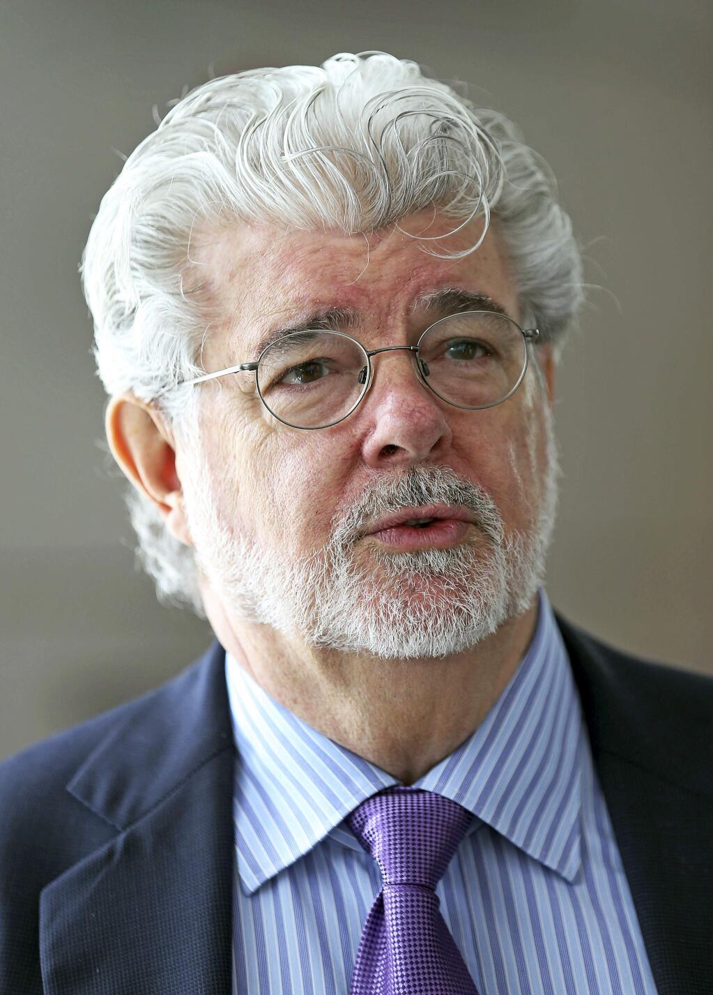 FILE - In this Jan. 16, 2014 file photo, George Lucas speaks at an event in Singapore. 'Star Wars' creator Lucas and his team announced Tuesday, Jan. 10, 2017, they have chosen Los Angeles over San Francisco as the home of the museum that will showcase his work. After what organizers called an extremely difficult decision, they announced Tuesday that the museum will be built in Exposition Park in Los Angeles, where it will sit alongside other more traditional museums. (AP Photo/Wong Maye-E, File)