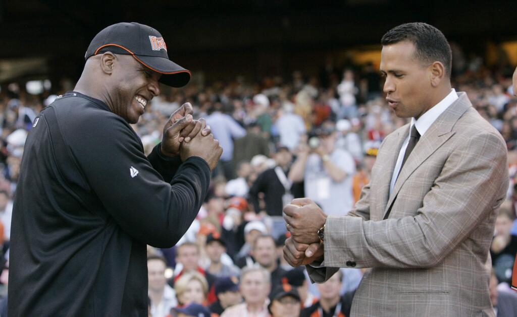 FILE - In this July 9, 2007, file photo, American League's Alex Rodriguez, right, of the New York Yankees, compares grips with National League's Barry Bonds, of the San Francisco Giants, during the All-Star Home Run Baseball Derby in San Francisco. Rodriguez is getting hitting tips from Bonds as the Yankees third baseman prepares to return from a season-long suspension. Rodriguez spokesman Ron Berkowitz confirmed the workouts, which the San Francisco Chronicle reported Wednesday, Jan. 21, 2015, took place at the Future Prospects batting cages in San Rafael, Calif. (AP Photo/Jeff Chiu, File)