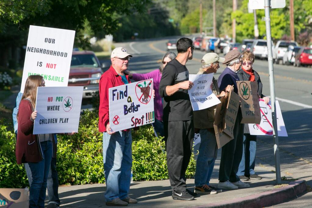 Protestors in front of the Firehouse Center in Glen Ellen, on Monday, May 14, object to a proposed medicinal dispensary in the building - adjacent to their residential neighborhood. (Photo by Julie Vader/Special to the Index-Tribune)