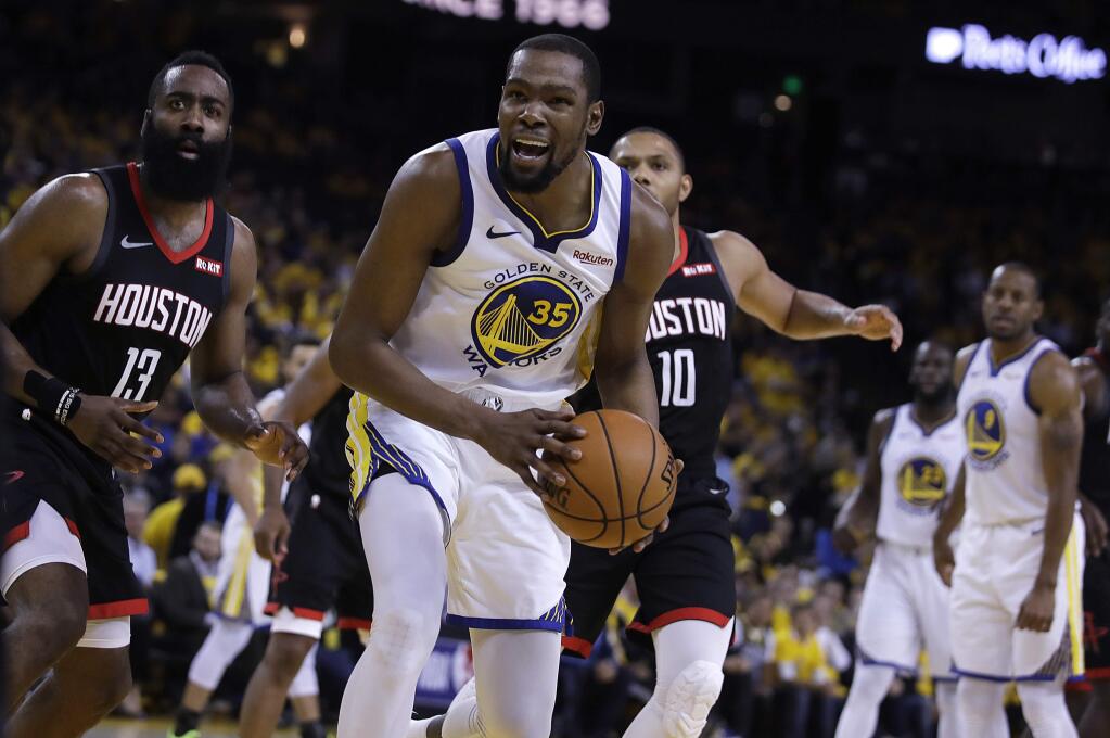 The Houston Rockets' James Harden, left, and the Golden State Warriors' Kevin Durant react to a referee's call during the second half of Game 5 of a second-round playoff series Wednesday, May 8, 2019, in Oakland. (AP Photo/Ben Margot)