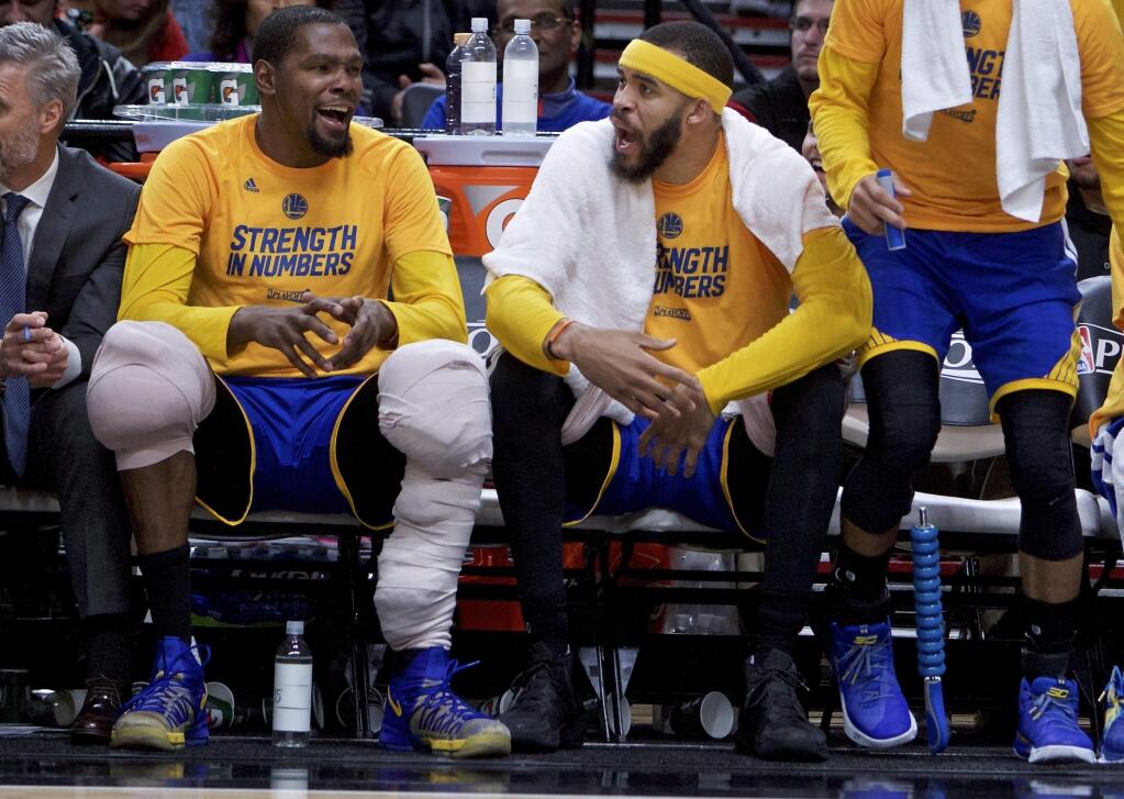FILE - In this April 24, 2017, file photo, Golden State Warriors forward Kevin Durant, left, and center JaVale McGee react at the end of the game against the Portland Trail Blazers during Game 4 of an NBA basketball first-round playoff series, in Portland, Ore. From Cleveland to Oakland, the two star-studded teams expected to rematch once more in the NBA Finals have ample time to rest up, get healthy and prepare for the next opponent. (AP Photo/Craig Mitchelldyer, File)