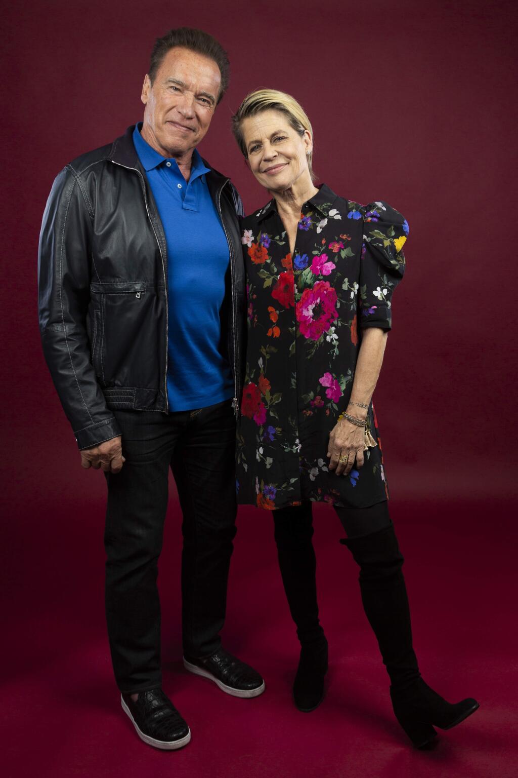 This Oct. 26, 2019 photo shows actor Arnold Schwarzenegger, left, and actress Linda Hamilton posing for a portrait to promote the film, 'Terminator: Dark Fate' at the Four Seasons Hotel Los Angeles at Beverly Hills in Los Angeles. (Photo by Willy Sanjuan/Invision/AP)