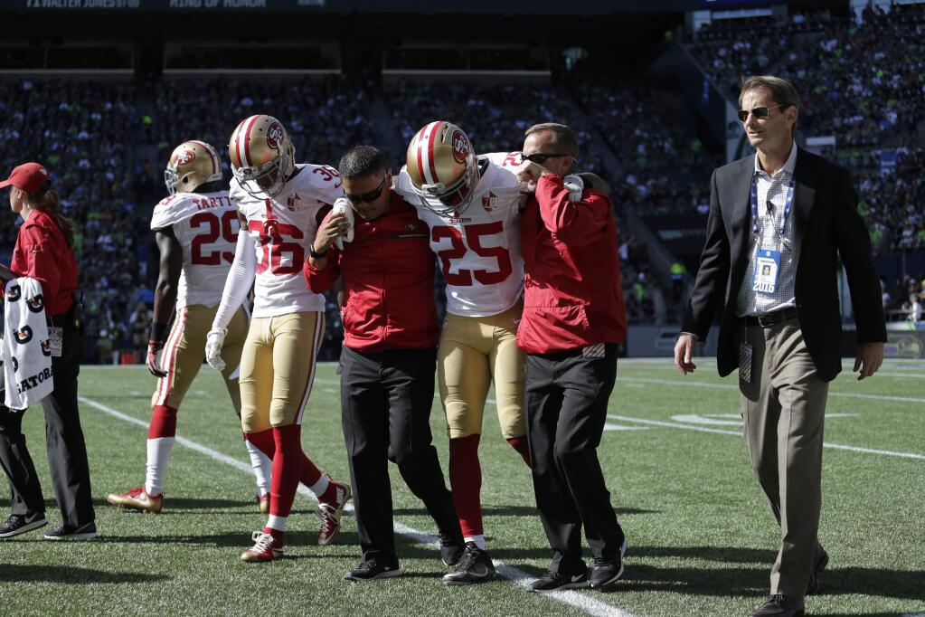 San Francisco 49ers' Jimmie Ward (25) is helped off the field with an injury after a play in the first half against the Seattle Seahawks, Sunday, Sept. 25, 2016, in Seattle. (AP Photo/John Froschauer)