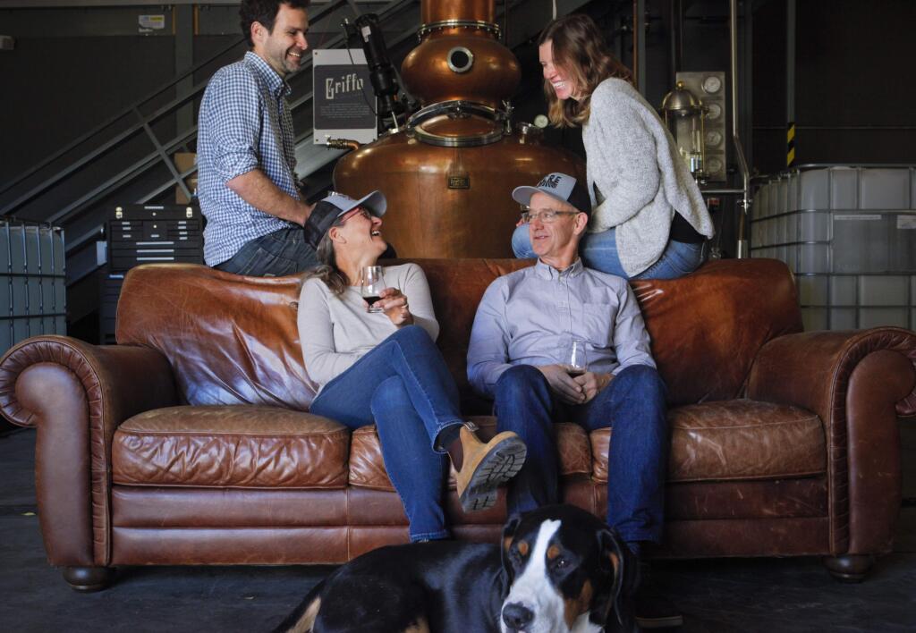 Petaluma, California, USA. Monday, December 04, 2017. _ Griffo Distillery teamed up with Acre Coffee to create a coffee liquer that will be released at a Big Lebowski party. L-R: Michael Griffo; Britt Galler of Acre Gourmet; Steve DeCosse, owner of Acre and Jenny Griffo. The Griffo's puppy, Cooper, in front. (PHOTO BY CRISSY PASCUAL/ARGUS-COURIER STAFF)