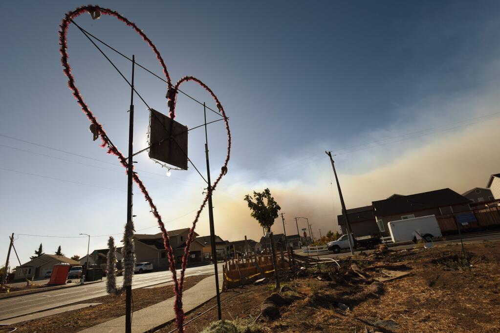 Coffey Park is empty and quiet after receiving a mandatory evacuation order Sunday, Oct. 27, 2019, as a stream of thick smoke flows from the Kincade fire just north of the neighborhood. (Erik Castro/for The Press Democrat)