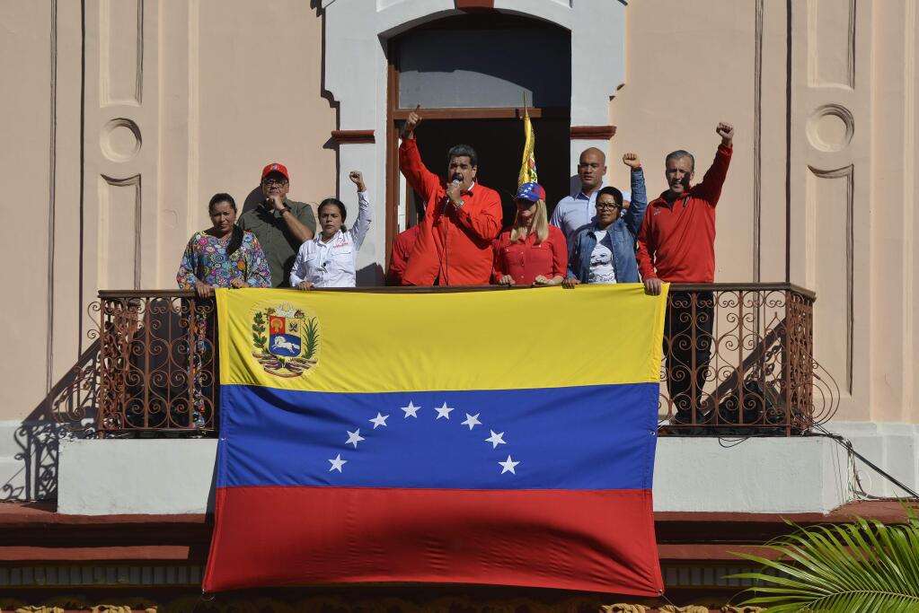 Venezuelan President Nicolas Maduro speaks to supporters from a balcony at Miraflores presidential palace during a rally marking the anniversary of the coup that overthrew dictator Marcos Perez Jimenez in 1958, in Caracas, Venezuela, Thursday, Jan. 23, 2020. (AP Photo/Matias Delacroix)