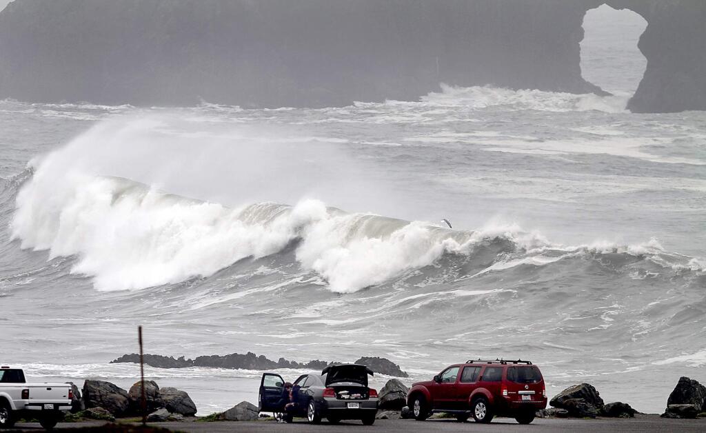 3/31/2012: B1:PC: With Arch Rock in the background, large waves crash ashore at Goat Rock State Beach, Friday March 30, 2012, as a strong early spring storm bears down on Sonoma County. (Kent Porter / Press Democrat) 2012