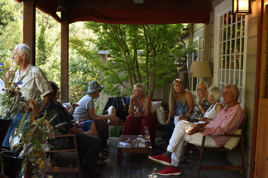 Guests relaxing with some wine and conversation during an evening of wine, poetry, music and spa treatments held at the Osmosis Day Spa Sanctuary in Freestone, California. All proceeds of the event benefit The Center For Climate Protection. August 15, 2019.(Photo: Erik Castro/for The Press Democrat)