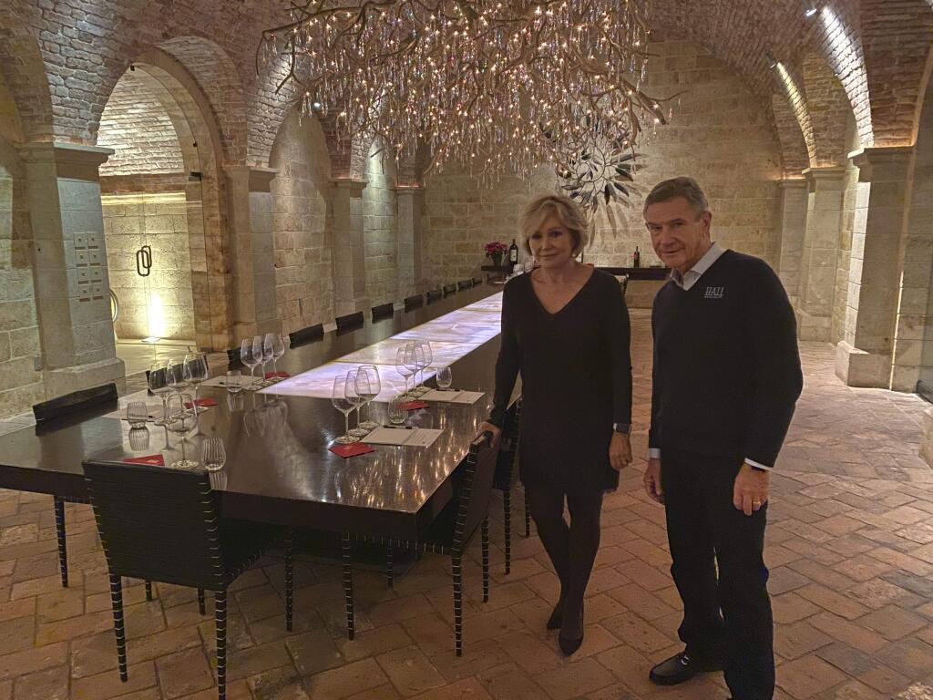 Kathryn and Craig Hall, owners of Hall Rutherford Winery, stand inside the “wine cave” dining room where they held a fundraising dinner for Democratic presidential candidate South Bend, Ind., Mayor Pete Buttigieg, Friday, Dec. 20, 2019, in Rutherford, Calif. They say their most expensive bottle of wine costs $350 and wasn't served at the fundraiser. (AP Photo/Terence Chea)