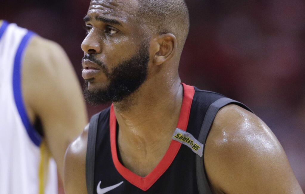 Houston Rockets guard Chris Paul wears the Santa Fe High School logo during the first half in Game 5 of the team's NBA basketball playoffs Western Conference finals against the Golden State Warriors in Houston, Thursday, May 24, 2018. Ten people were killed in shootings at the school last week.(AP Photo/David J. Phillip)