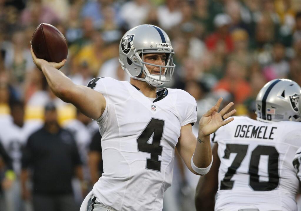 Oakland Raiders quarterback Derek Carr (4) throws against the Green Bay Packers during the first half of an preseason game in Green Bay, Wis., Thursday, Aug. 18, 2016. (AP Photo/Mike Roemer)