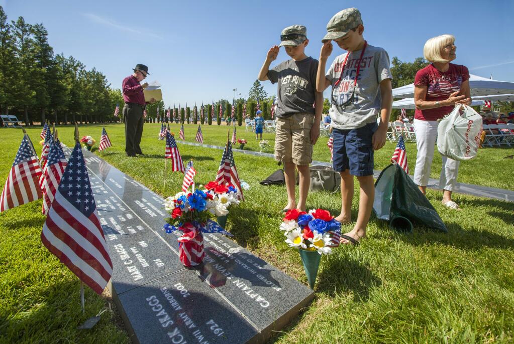 Liam Marchi, 11, (left) and his brother Cooper, 9, trimmed the grass, placed flowers and saluted to the memory of their uncle Capt. Kevin Norman, who died in Korea in 2003 when the C-12 Huron he was piloting crashed.The annual Sonoma Valley Memorial Day Observance at the Sonoma Veterans Memorial Park will be held on Monday, May 29.