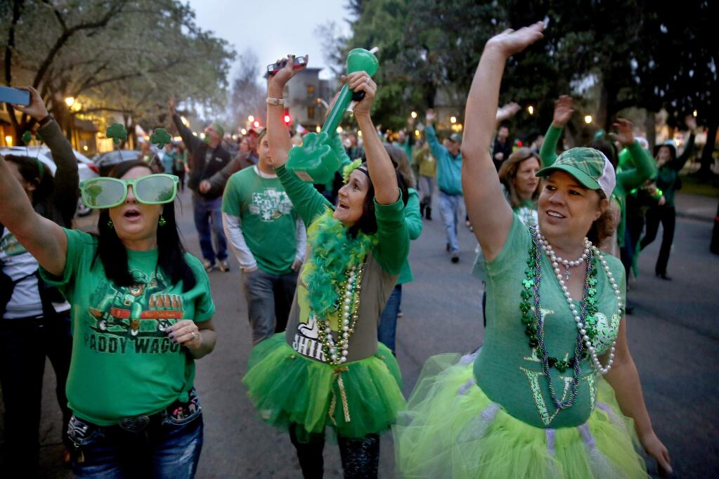 (From left)Michelle Woogerd, her sister Dee, and Carol Ferrari take part in the St. Patrick's Day parade on in Healdsburg, on Tuesday, March 17, 2015. (BETH SCHLANKER/ The Press Democrat)