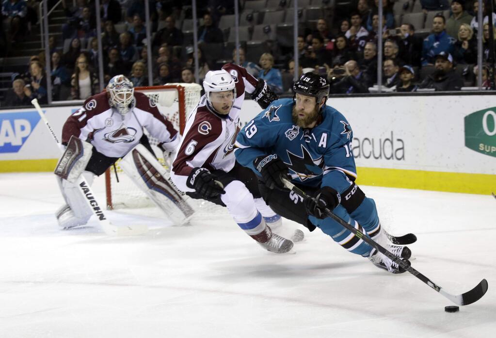 San Jose Sharks' Joe Thornton (19) is chased by Colorado Avalanche's Erik Johnson (6) during the first period of an NHL hockey game Tuesday, Jan. 26, 2016, in San Jose, Calif. (AP Photo/Marcio Jose Sanchez)