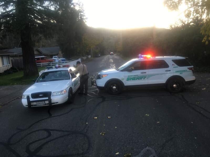 Sonoma County sheriff's deputies enforce a closure of Melita Road in Santa Rosa after a robbery suspect shot himself Friday, Dec. 2, 2016 (John Burgess/The Press Democrat).