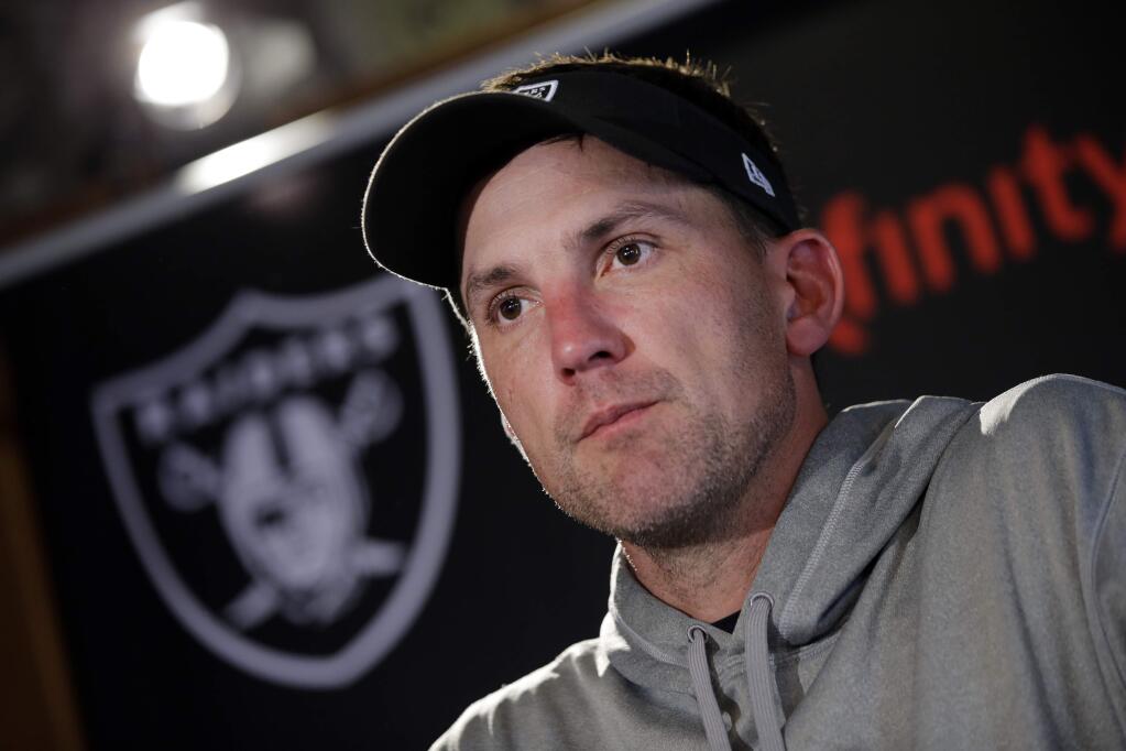 Oakland Raiders head coach Dennis Allen answers a reporter's question during a media conference following a training session at Pennyhill Park, Bagshot, England, Thursday, Sept. 25, 2014. The Raiders will play the Miami Dolphins in an NFL football game at London's Wembley Stadium on Sunday Sept. 28.(AP Photo/Lefteris Pitarakis)