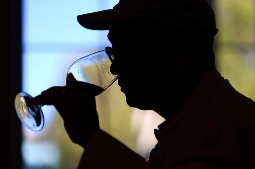 Wilfred Wong samples the aroma of a wine while judging Harvest Fair entries. (Christopher Chung/ The Press Democrat)