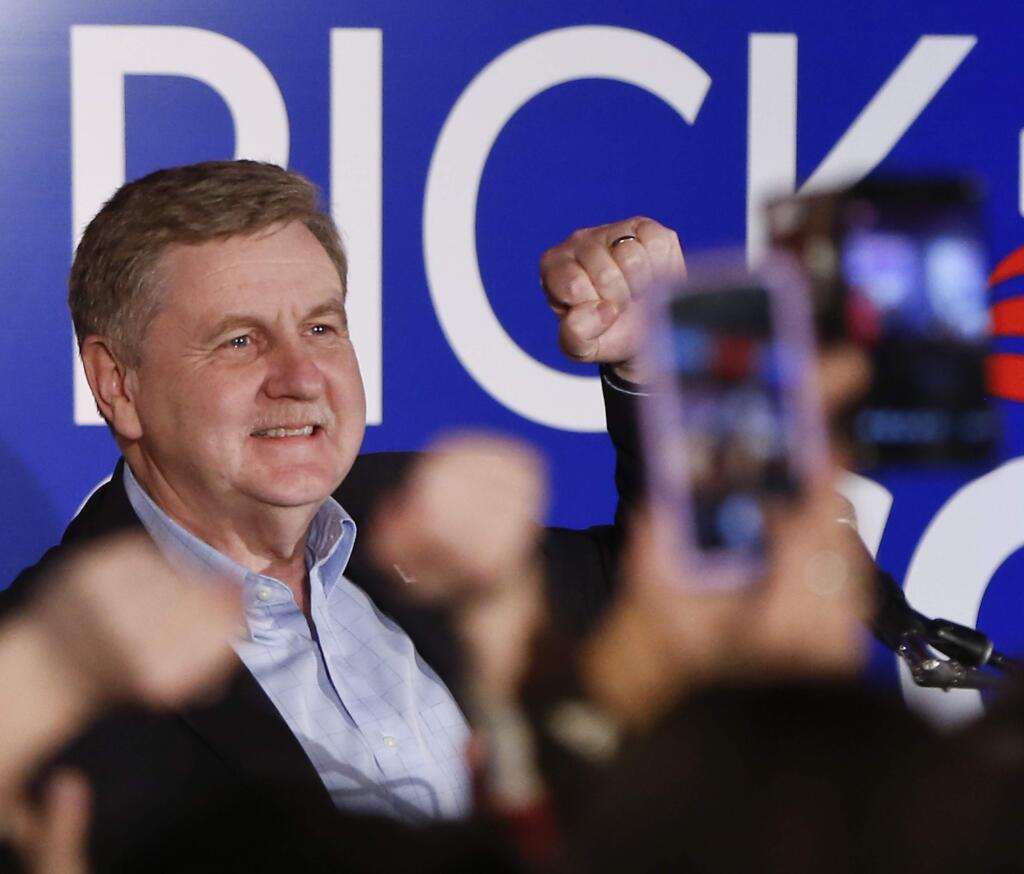 Republican Rick Saccone pumps his fist as he thanks supporters at the party watching the returns for a special election being held for the Pennsylvania 18th Congressional District vacated by Republican Tim Murphy, Tuesday, March 13, 2018 in McKeesport, Pa. A razor's edge separated Democrat Conor Lamb and Saccone Tuesday night in their closely watched special election in Pennsylvania, where a surprisingly strong bid by first-time candidate Lamb was testing Donald Trump's sway in a GOP stronghold. (AP Photo/Keith Srakocic)