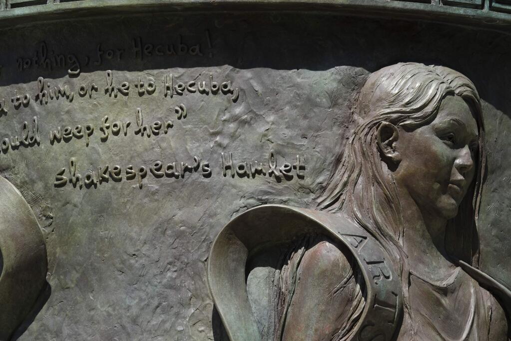 A statue of the legendary queen of Troy with a quote by William Shakespeare with the name spelled 'Shakespear' is seen on the campus of the University of Southern California in Los Angeles on Tuesday, Aug. 22, 2017. 'To E, or not to E, that is the question,' the school responded in a statement Tuesday when asked why Shakespeare's name is missing the last letter E in a quotation attributed to him. (AP Photo/Richard Vogel)