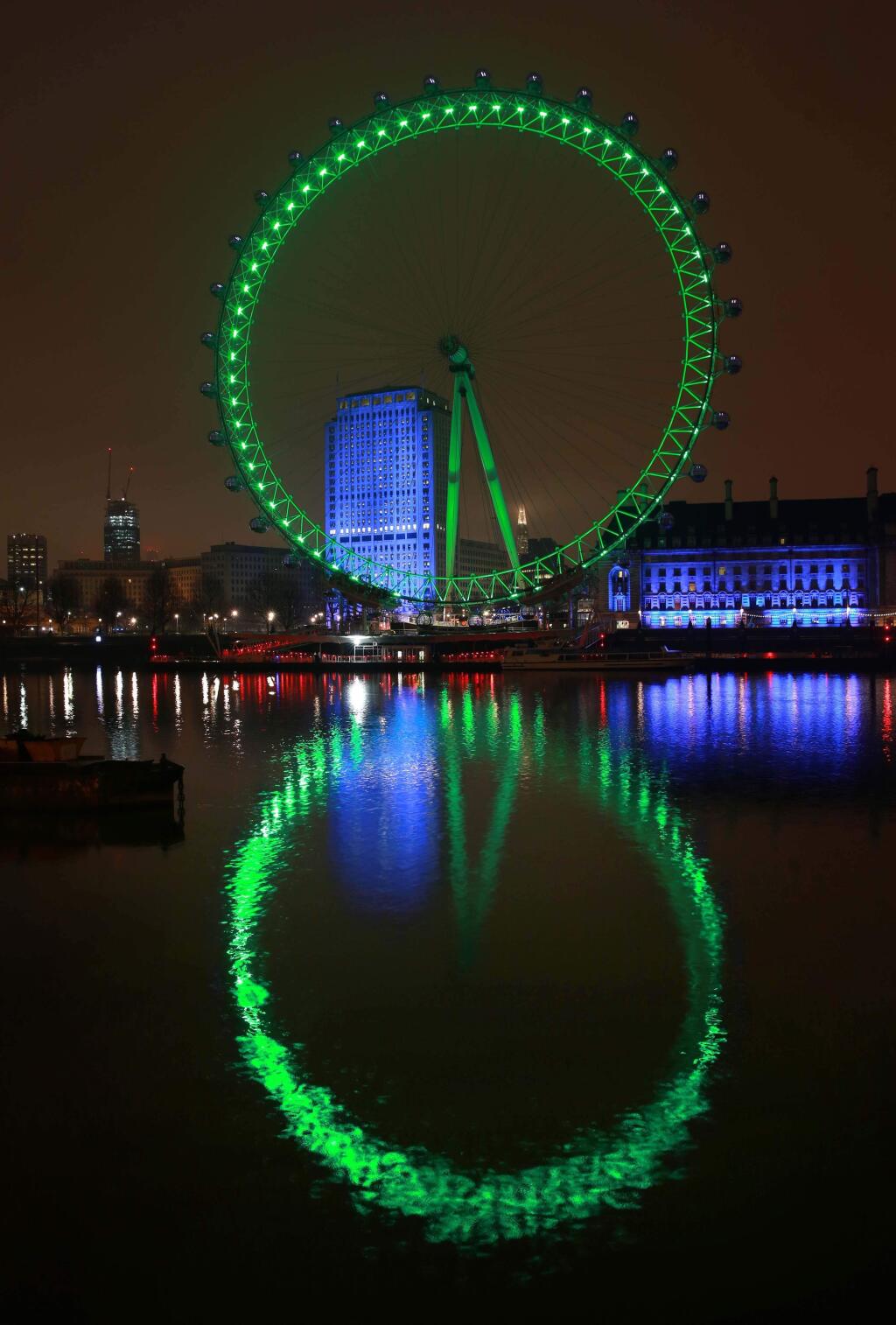 This image supplied by Tourism Ireland on Monday March 16, 2015 shows the London Eye floodlit green to celebrate St Patrick's Day on Tuesday. Landmark buildings across Ireland and the world have been floodlit green as global celebrations of the Emerald Isle's patron saint are culminating in parades and celebrations in Dublin and other cities, particularly in the U.S., on St. Patrick's Day. (AP Photo/Matt Alexander, Tourism Ireland)