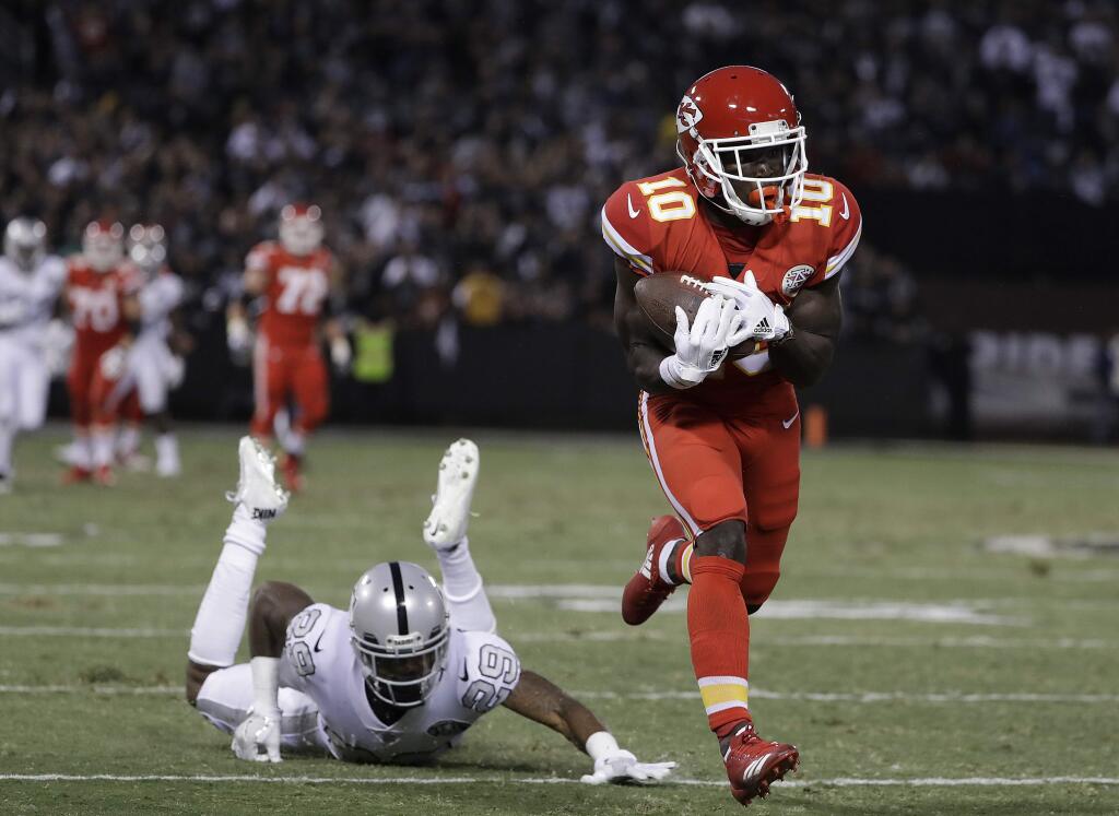 Kansas City Chiefs wide receiver Tyreek Hill (10) catches a touchdown past Oakland Raiders cornerback David Amerson (29) during the first half Thursday, Oct. 19, 2017. (AP Photo/Marcio Jose Sanchez)