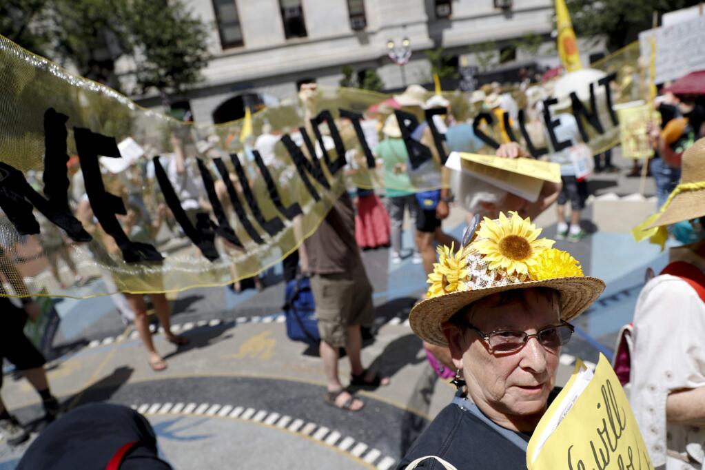 Environmental protesters arrive for a demonstrators at Dillworth Park on Sunday, July 24, 2016, in Philadelphia. The Democratic National Convention starts Monday in Philadelphia. (AP Photo/John Minchillo)