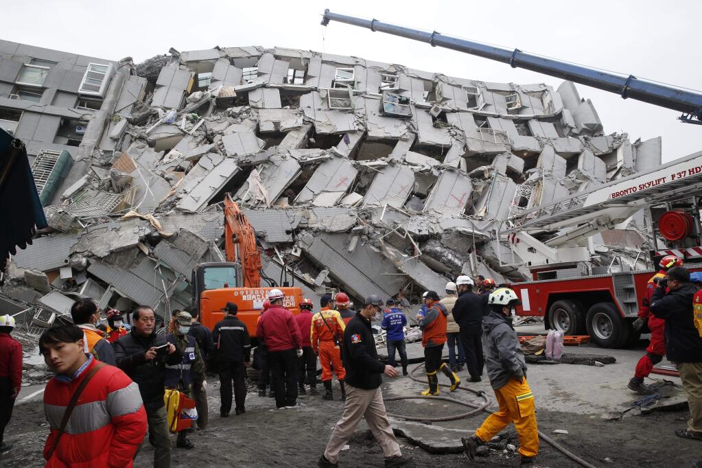 Rescue workers search a collapsed building following a Feb. 6 earthquake in Tainan, Taiwan. (WALLY SANTANA / Associated Press)