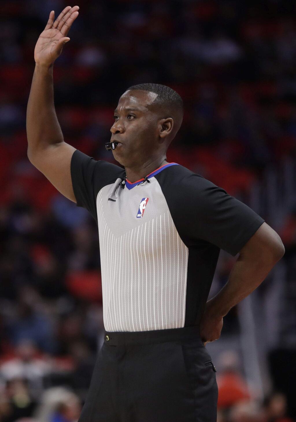 Referee James Williams signals during the first half of a game between the Detroit Pistons and the Atlanta Hawks, Friday, Nov. 10, 2017, in Detroit. (AP Photo/Carlos Osorio)